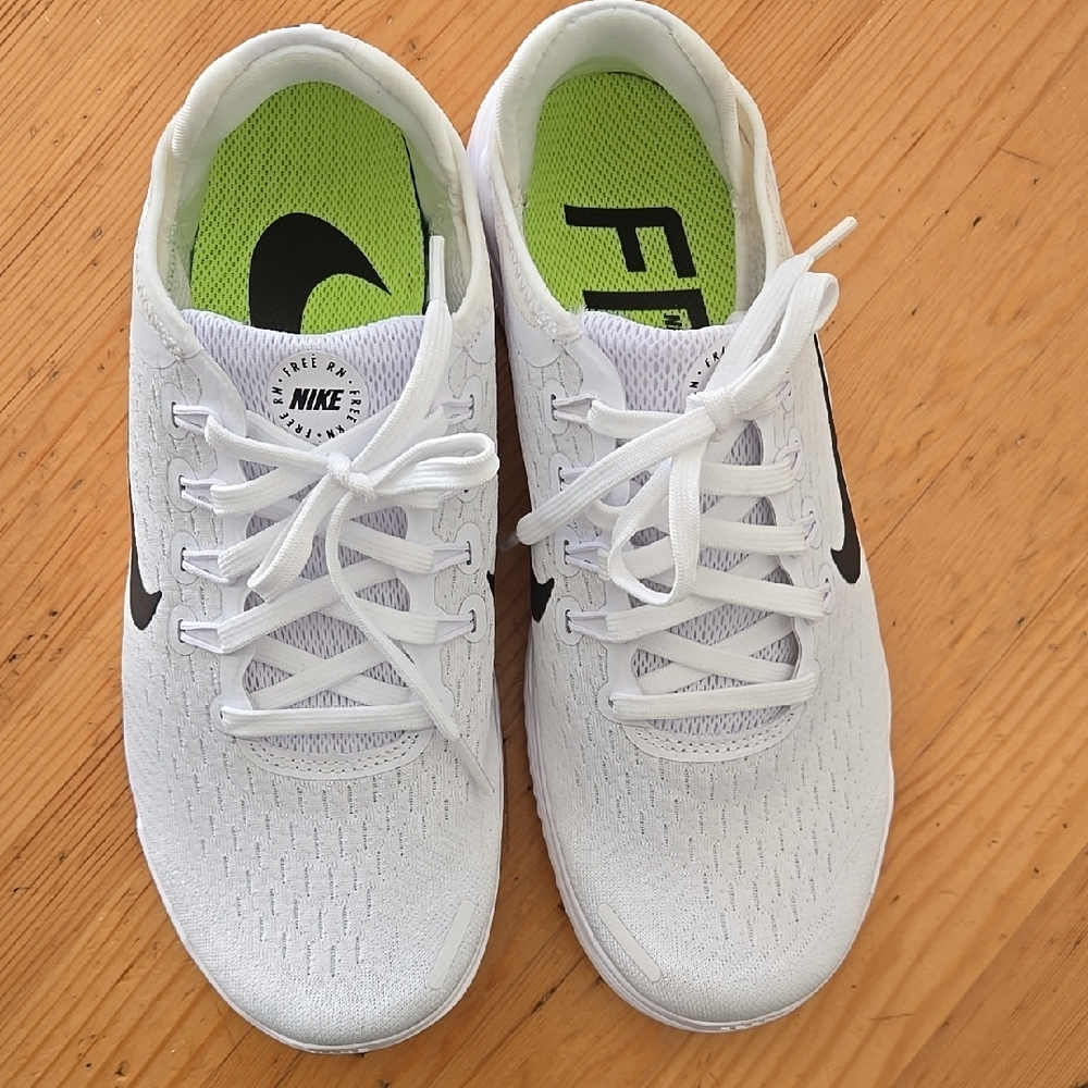 Nike White Athletic Shoes with Black Swoosh